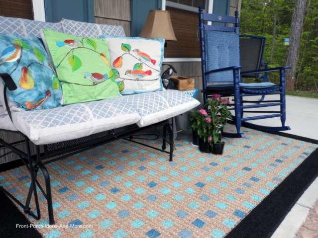 Outdoor rugs can be used on almost any size porch to add color and warmth. For a covered porch, you could use an inexpensive indoor rug like we do.