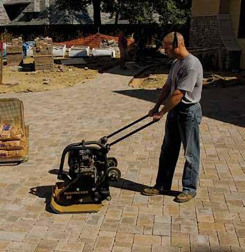 Figure 9. Compacting the pavers and bedding sand. Figure 10. Spreading and sweeping joint sand.