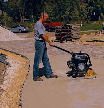 Figure 11. Vibrating sand into the joints. the pavement. Pavers are cut with a double bladed splitter or a masonry saw. See Figure 8. A saw gives a smooth cut. Gaps greater than 3 /8 in.
