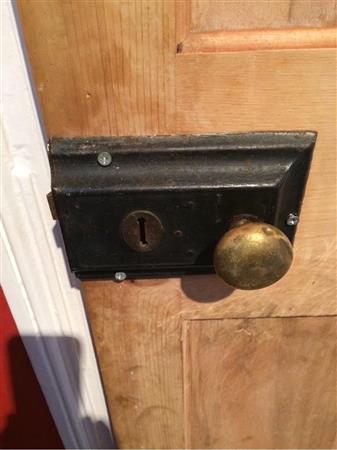 Brass knob dented and tarnished.