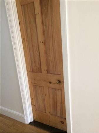 Door to kitchen. Stripped pine effect 4 panel door, fair condition.