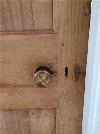 Tarnished door knob damaged, dead lock.