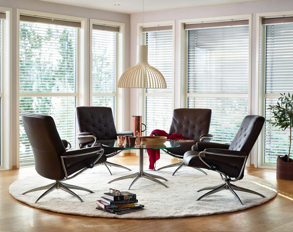 Stressless Metro Low Back recliners are shown in Paloma Chocolate. Stressless Urban Large table.