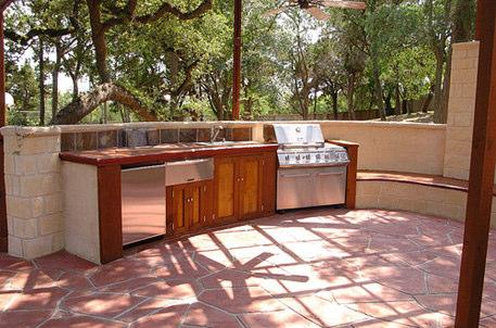 Place the outdoor kitchen under existing shade such as that from trees and vines as they ventilate easily and as an added bonus, vines and trees "transpire" to evaporate moisture for cooling