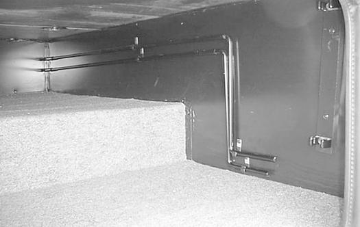 The cranks are stored on clips on the wall of an exterior storage compartment.
