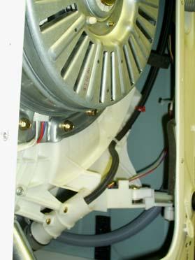 This plastic chamber is located behind the drum, near the bottom (See below.
