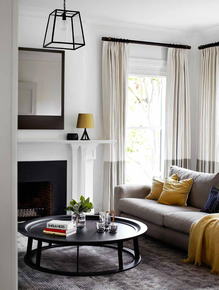 melbourne home this page In the formal living room, Obi coffee table is by Linteloo. The mirror, pendant light and wool/silk rug were all designed by Robson Rak.