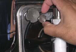 With an empty Stainless Steel Cylinder beneath the door spout, move the draw handle to the right.