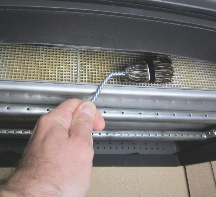 See the directions below to inspect and clean the combustor with the included brush.