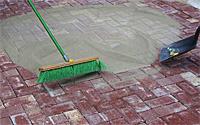 Sanding the Joints (Continued) Pour or shovel the sand onto the brick pavers and sweep into the joints using a push broom. Run the compactor over the surface of the pavers.