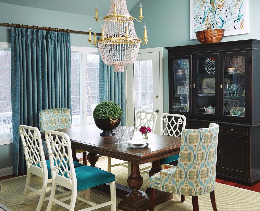 ample light via the skylights. Turquoise fabric on the chairs gives the room a jolt of color, and an unusual chandelier draws the eye up.