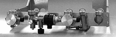 FIXING JIG The fixing jig is made up, from left to right, as follows: A- Heating return fitting with isolating valve(v) and drain knob (u).