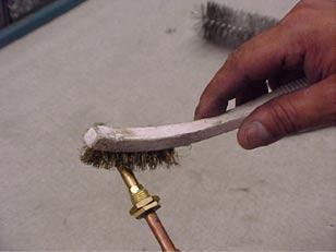 Step 16 Use a brush or compressed air to clean the burner orifice.