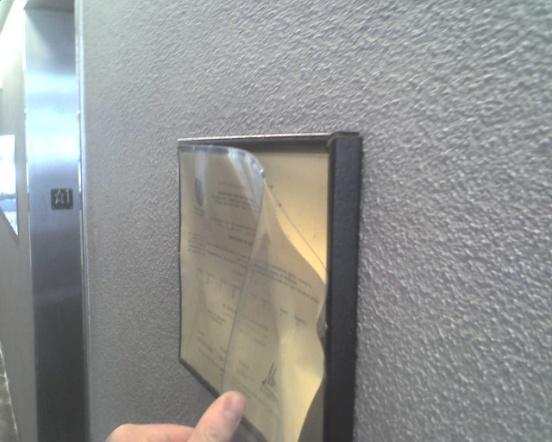 Please put the permit into the frame, and re-hang the frame (Employee s should use the black frames that are at some locations on campus).