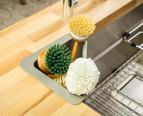Sink Butler Designed to fit in the corner of the sink, the removable caddy keeps prep tools neatly contained at your