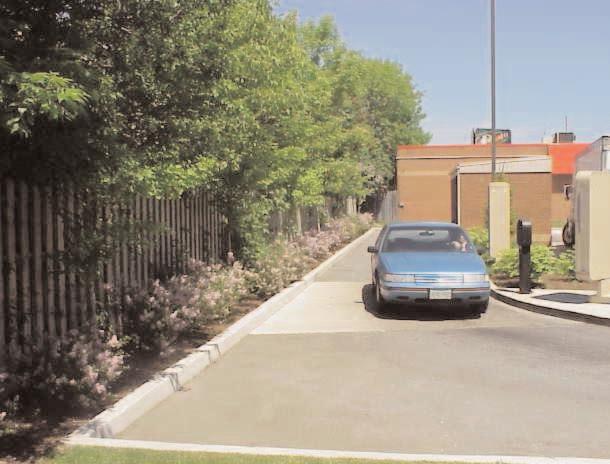 When designing sites with drive-through facilities: screen stacking lanes, driveways, parking, utilities and services including transformers, gas meters, loading and garbage pick up from view along