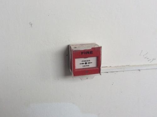 Replace the fire alarm system with a new, listed addressable fire alarm system in accordance with NFPA 72.