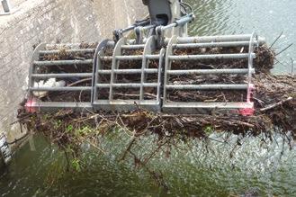 Using the climate controlled cab, the operator can manually remove floating debris, skim the water surface, lift gates and stop
