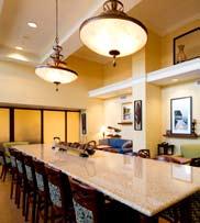 Two story lobbies are required to implement pendant lighting over the community table.