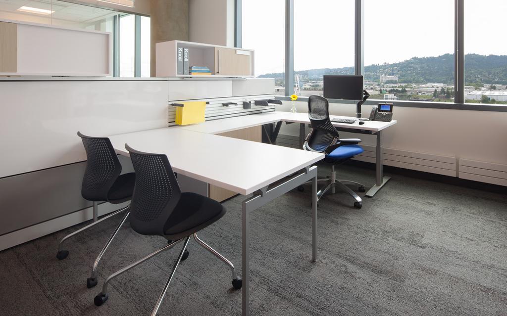 Workstations for managers include room for casual meetings with visitors.