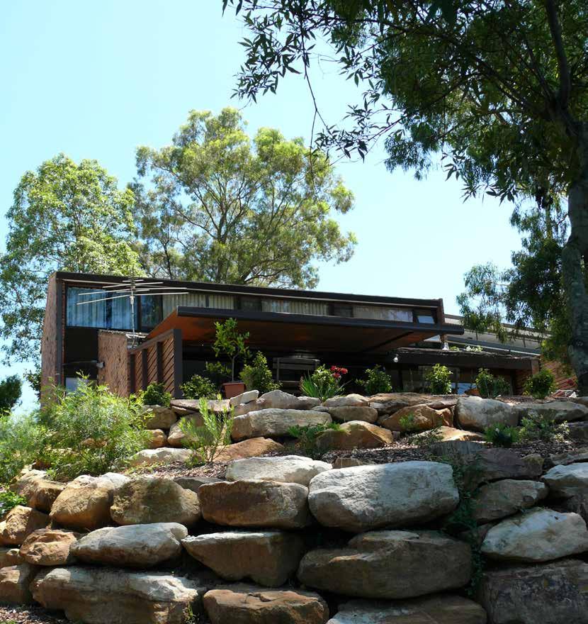 This unusable and steep backyard was terraced with Sandstone Boulders creating