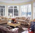Window walls, like this, made from picture windows and transoms, open a room to the
