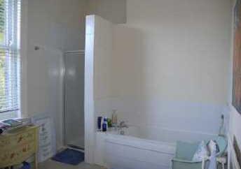 HOUSE BATHROOM This spacious room has a panelled bath, separate shower cubicle, close coupled wc with top flush and pedestal wash hand basin with
