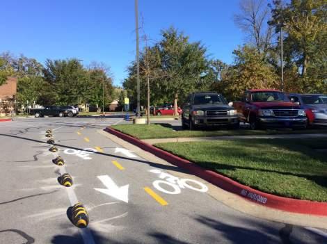 A demonstration that marked out a curbside extension with traffic cones might be improved by a pilot project with bright paint and decorative barriers.