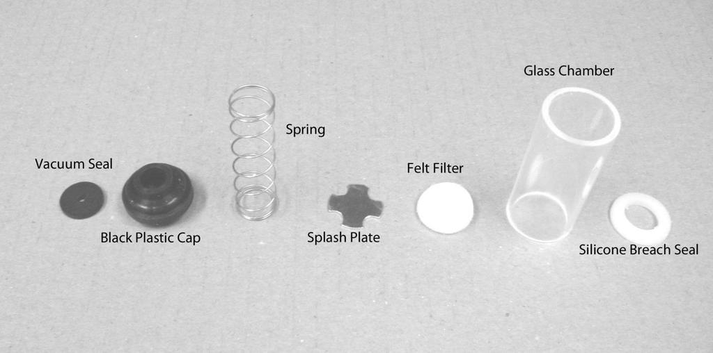 Figure 6 From left to right these parts are the Vacuum Seal, Black Plastic Cap, Spring, Splash Plate, Felt Debris Filter, Chamber, and Silicone Breach Seal.