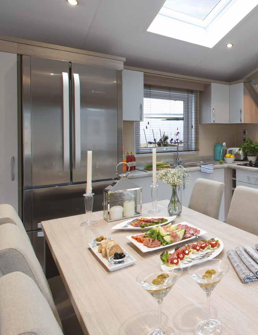 Artisan Lodge The kitchen blends style with practicality and the pastel grey feature cabinets add that touch of class.