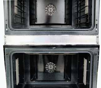 Remove the three ¼-in. hex-head screws that attach the bottom of the control panel to the vent trim. 3. 4. Remove the 2 Phillips-head screws from the top of the middle trim. Open the lower oven door.