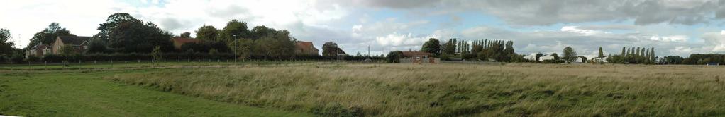 The site is mainly open grassland with a raised bund to the north and young woodland planting on a bund to the southern boundary adjacent HMP Wealstun.