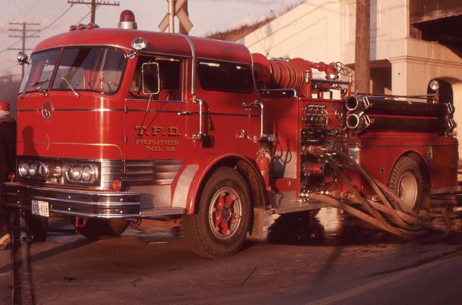 Fire trucks working, a historical perspective Working a second alarm in their district in 1975, Toronto Pumper 12's