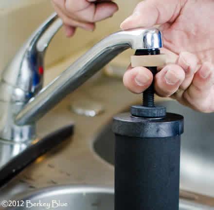 Step 3) While holding the priming button against the faucet, turn on the cold water