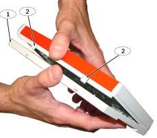Using a small flat-bladed screwdriver, gently push the two bottom tabs up and in to release the