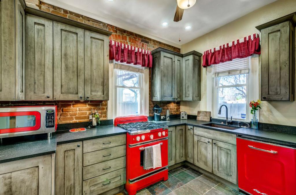 This kitchen uses Big Chill appliances in classic cherry red to