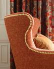 Drapery: Renaud Embroidery, color Mocha/Spice 8015157-692; Furniture: Bellechasse Chair BR-2544 in Guarinot, color Tangerine 8015161-22; Pillow: Aime Strie, color Rust/Green 8015153-243 Furniture: