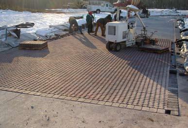 The start of this process is illustrated in Figure 4. After the 2 in. (50 mm) thick CA-16 bedding layer is in place, the units were supplied to the project in a ready-to-install laying pattern.