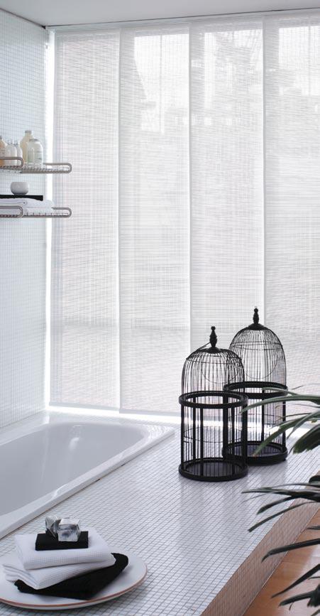 The blinds encompass large panels of fabric which stack neatly behind one another when open, allowing maximum light into the room.