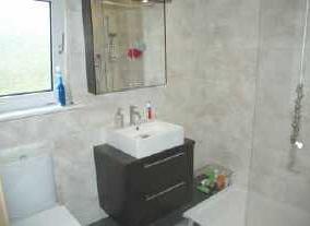 06M) Bedroom three has window to the rear, wash hand basin built into vanity unit, central heating radiator.