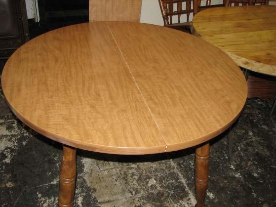 Table Dining, round, wood/laminate Light brown 42 round Has a leaf that is 12 wide