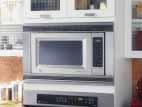 Microwave Ovens This trim kit allows for built-in installation of the 1.8 countertop microwave oven in a wall or cabinet alone, or over a 30" single electric wall oven as shown.