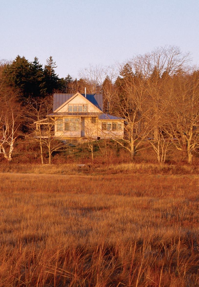 Morning on the marsh. Windows on the east side of the house catch the early-morning sun as it rises over the estuary.