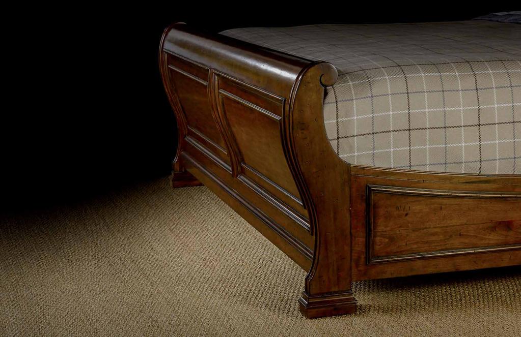 BEDROOM A dramatic sleigh bed accented by leather insets, and a panel bed with tall headboard showcasing figured Alder veneers highlight the Tynecastle bedroom