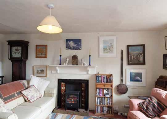 Ground Floor From the farmyard, a small, walled garden leads to the front door beneath an open porch to the hall with stone floor and doors to the sitting room to one side and living room to the