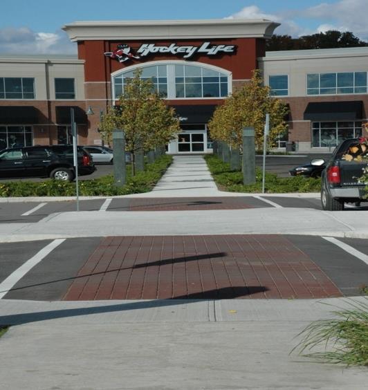 21212121211 Sportsworld Crossing provides a well designed pedestrian walkway through a busy parking area.