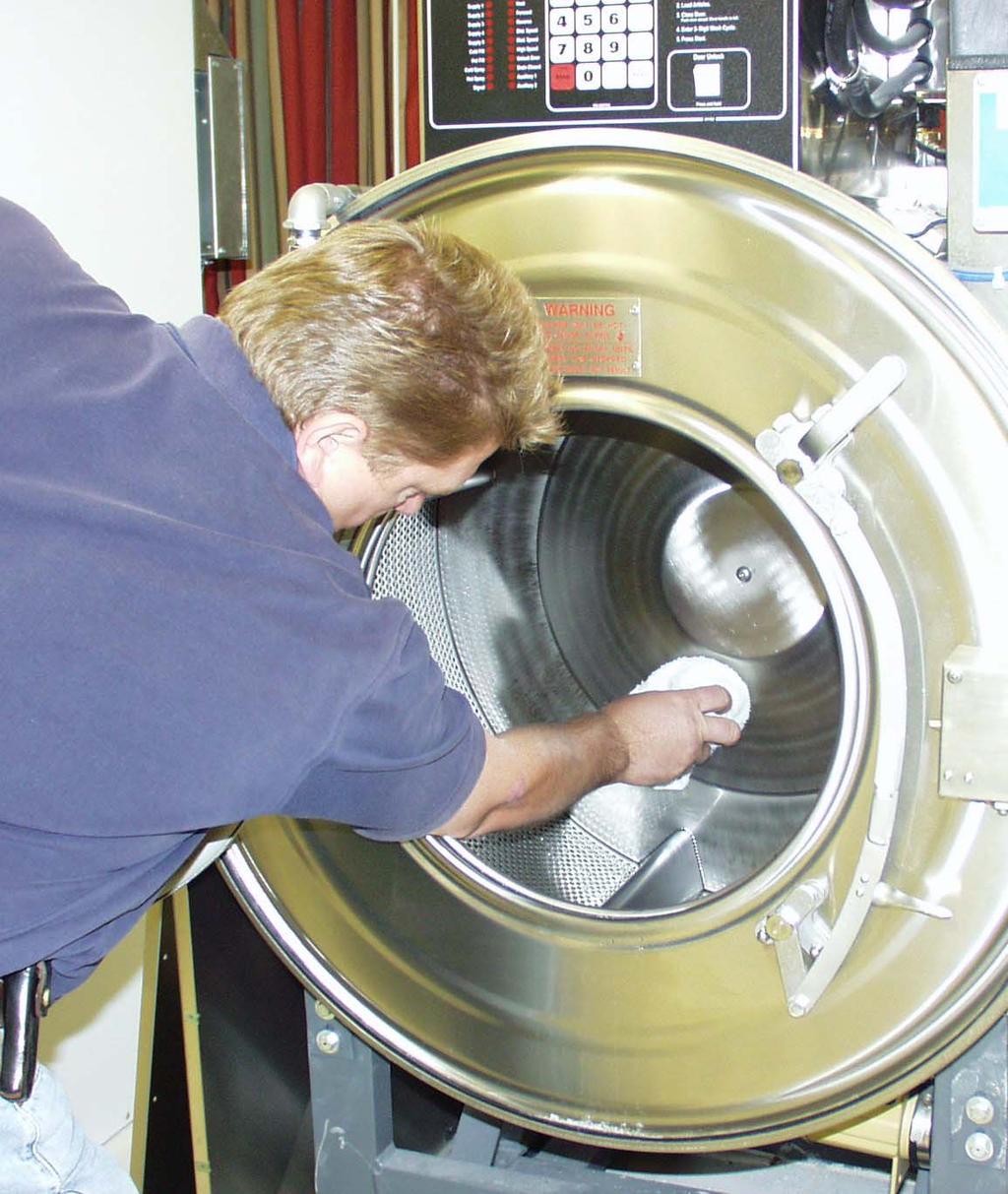Clean the interior of the washer-extractor, both the