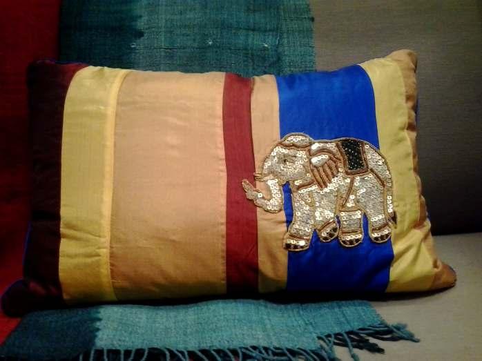 Exquisitely embroidered patchworked elephant cushions from Myanmar evoke tales from the ancient land.