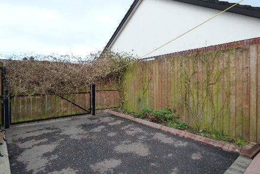 Generous tarmac driveway to side with vehicular gates.