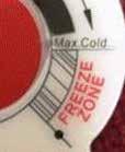 Remove the red portion of the Cold Tank Temperature label to access the adjustment screw.